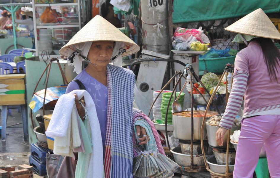 Viele Vietnamesinnen tragen den Reisstrohhut, der sie vor der intensiven Sonneneinwirkung schützt. 